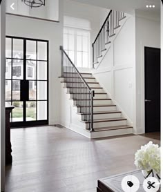 an open floor plan with stairs leading up to the second floor and another room in the background