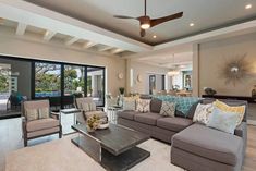 a living room filled with furniture and lots of windows