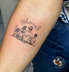 a tattoo on the arm of a man with two children