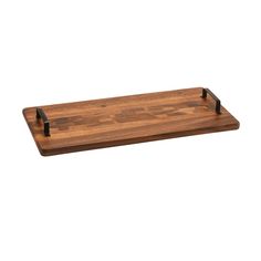 a wooden cutting board with black handles