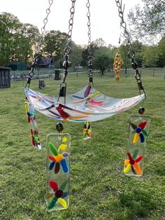 a glass wind chime in the middle of a grassy field