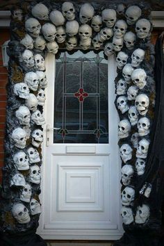 a bunch of skulls on the outside of a door