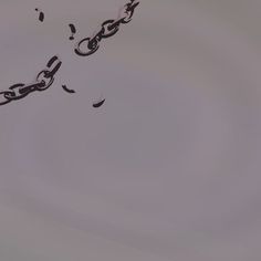 two kites flying in the sky with chains attached to them