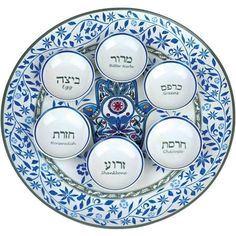 six white and blue plates with hebrew writing on them