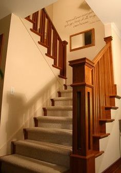 the stairs are made of wood and have carpeted treads on each one side