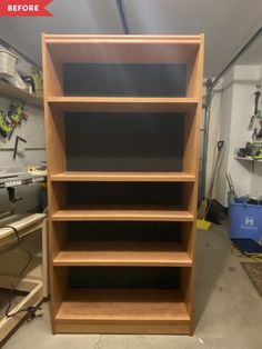 an unfinished bookcase in a garage with tools on the shelves