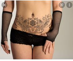 an image of a woman with tattoos on her stomach and panties in the shape of fishnet stockings