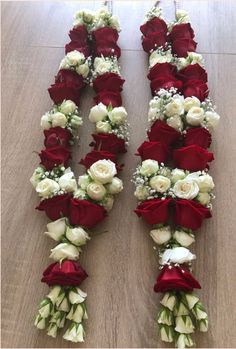 two rows of red and white roses arranged on the floor