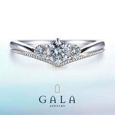 three stone diamond engagement ring in white gold with diamonds on each side and the word gala written below