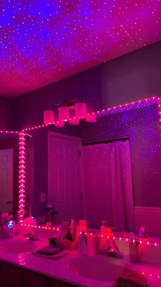 the bathroom is decorated with purple lights and stars on the ceiling, along with other decorations