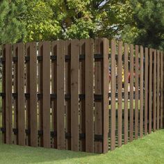 a wooden fence in the middle of some grass