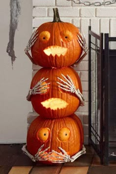 three pumpkins with faces carved into them