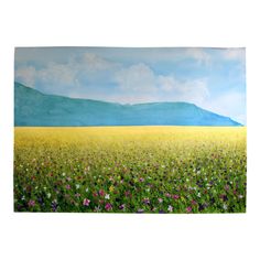 a painting of a field with flowers and mountains in the background