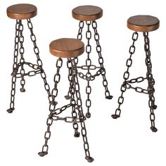 three metal stools with wooden tops and chains attached to the legs, on white background