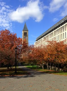 a large building with a clock tower in the middle of it's front yard