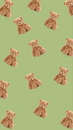 several brown teddy bears sitting together on a green background