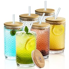 four glasses filled with different colored drinks