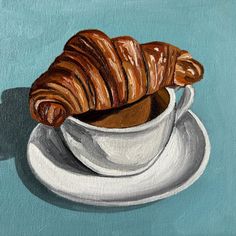 a painting of a croissant in a cup on a saucer