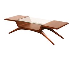 a wooden table with glass top and two sections on one end, in the shape of a rectangle