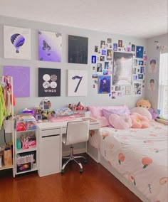 a bed room with a neatly made bed and lots of pictures on the wall