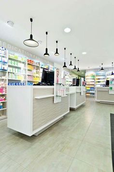 the inside of a pharmacy with shelves and lights