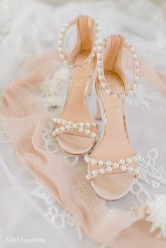 the bride's shoes are adorned with pearls