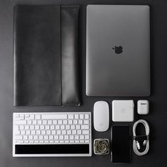 an apple computer, keyboard and accessories laid out on a table