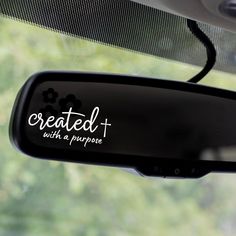 a car mirror with the words created with a purpose written on it