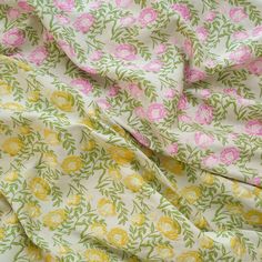 the fabric has pink and yellow flowers on it