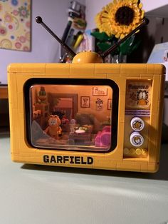 a yellow lego tv sitting on top of a table