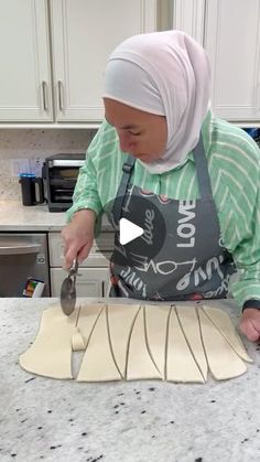 a woman in an apron is making some food