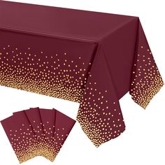 a table cloth with gold dots on it and four napkins in front of it