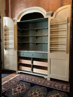 a large white cabinet with drawers and shelves