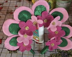 pink flowers with green leaves and glitters on them