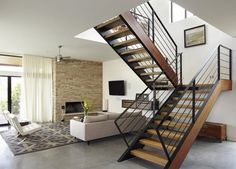 a living room filled with furniture and a stair case