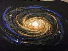 a black blanket with gold and blue swirls on it