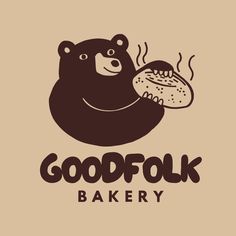 a bear holding a loaf of bread with the words goodfook bakery on it