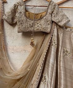 Features a vintage gold raw silk lehenga hand embellished with sequins, pearl and cutdana buttis and a zari and pearl work border. Paired with a matching raw silk blouse hand embroidered with zardozi, sequin and pearl work and a matching sequinned net dupatta Composition : Lehenga and Blouse - Raw Silk, Dupatta - Soft Net All products can be customised for sleeves, length of blouse and neck design Delivery : 2-4 weeks as the product is hand crafted. Check Size Guide or choose MySize for free customisation (All Sizes above XL can be made at 15% additional cost) For more information and sizes please contact fabiliciousfashion@gmail.com or visit our Copenhagen studio.About the Designer : Priti Sahni started out with a career on the well-trodden path by following typical Indian parent’s goal, Raw Silk Blouse, Raw Silk Lehenga, Zardosi Work, Tan Blouse, Pearl Work, Travel Infographic, Lehenga Designs Simple, Bridal Lehenga Collection, Dream Outfits