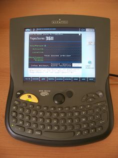 a computer keyboard sitting on top of a wooden table