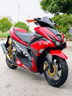 a red and black motorcycle parked on the street