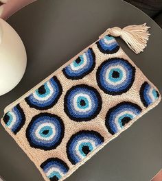 a blue and white purse sitting on top of a table