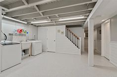 an empty laundry room with washer and dryer