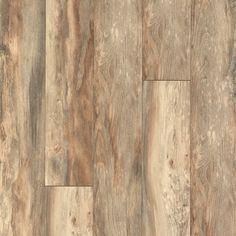 wood flooring that looks like it has been made from old planks and is light brown