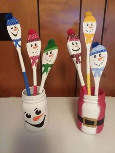 four snowman themed toothbrushes in a jar