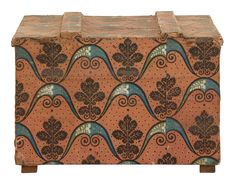 an old wooden box with decorative designs on it