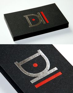 two black business cards with red and silver letters on them, one has an image of the letter d