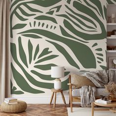 a living room with a couch, table and wallpaper on the walls in shades of green