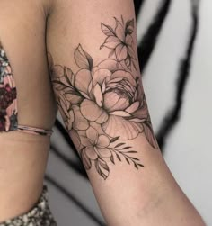 a woman's arm with flowers on it