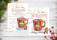 two mugs with christmas trees on them are sitting next to some candy canes