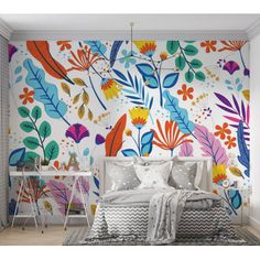 a bed sitting under a colorful wall mural